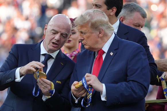FIFA President Gianni Infantino, left, President Donald J. Trump comment on the medals as they wait to congratulate the Spanish players after the World Cup final soccer match between Spain and Argenti ...