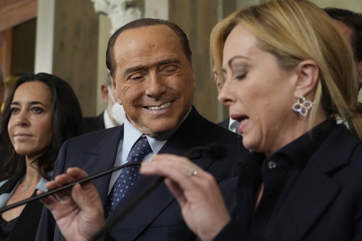 Forza Italia president Silvio Berlusconi looks to Brothers of Italy's leader Giorgia Meloni as she talks to the press at the Quirinale Presidential Palace after a meeting with Italian President S ...