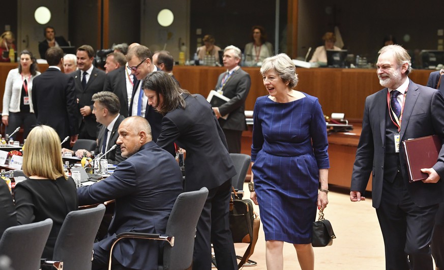 British Prime Minister Theresa May, second right, and British Ambassador to the EU Tim Barrow, right, arrive for a round table meeting at an EU summit in Brussels on Thursday, Oct. 19, 2017. British P ...