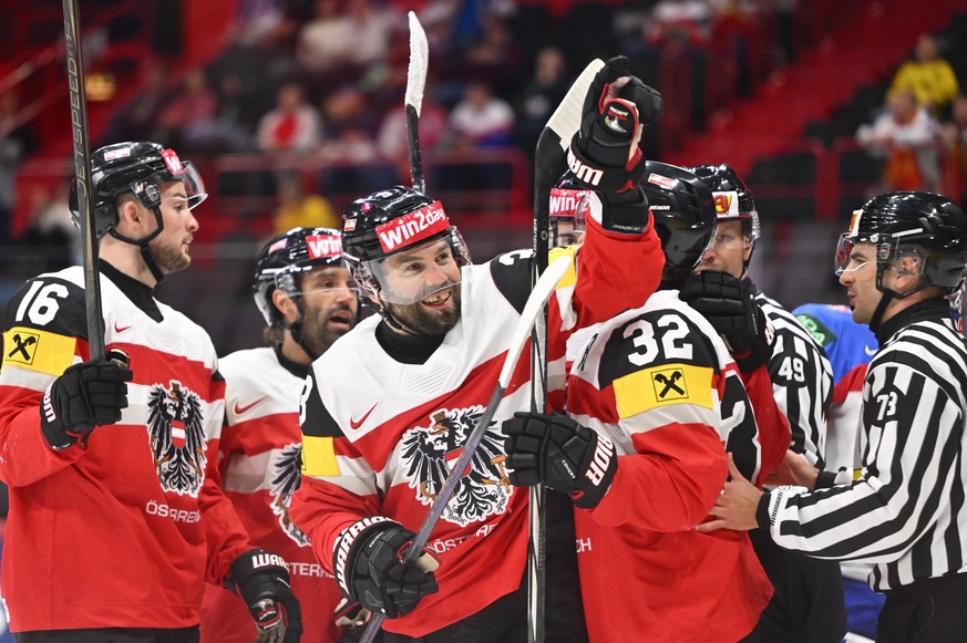 epa12094282 Austria&#039;s Peter Schneider (C) celebrates scoring the 1-0 goal during the IIHF Ice Hockey World Championship group A match between Austria and Slovakia, in Stockholm, Sweden, 12 May 20 ...
