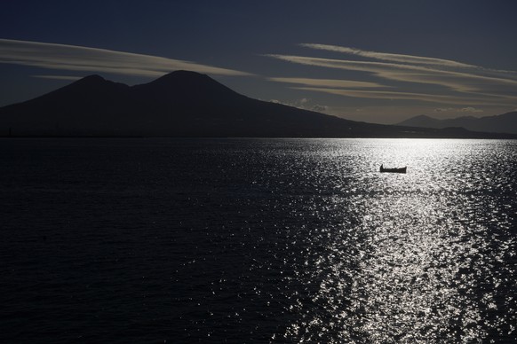 A boat sails past Vesuvius in Naples, Italy,Thursday, March 16, 2023. (AP Photo/Gregorio Borgia)