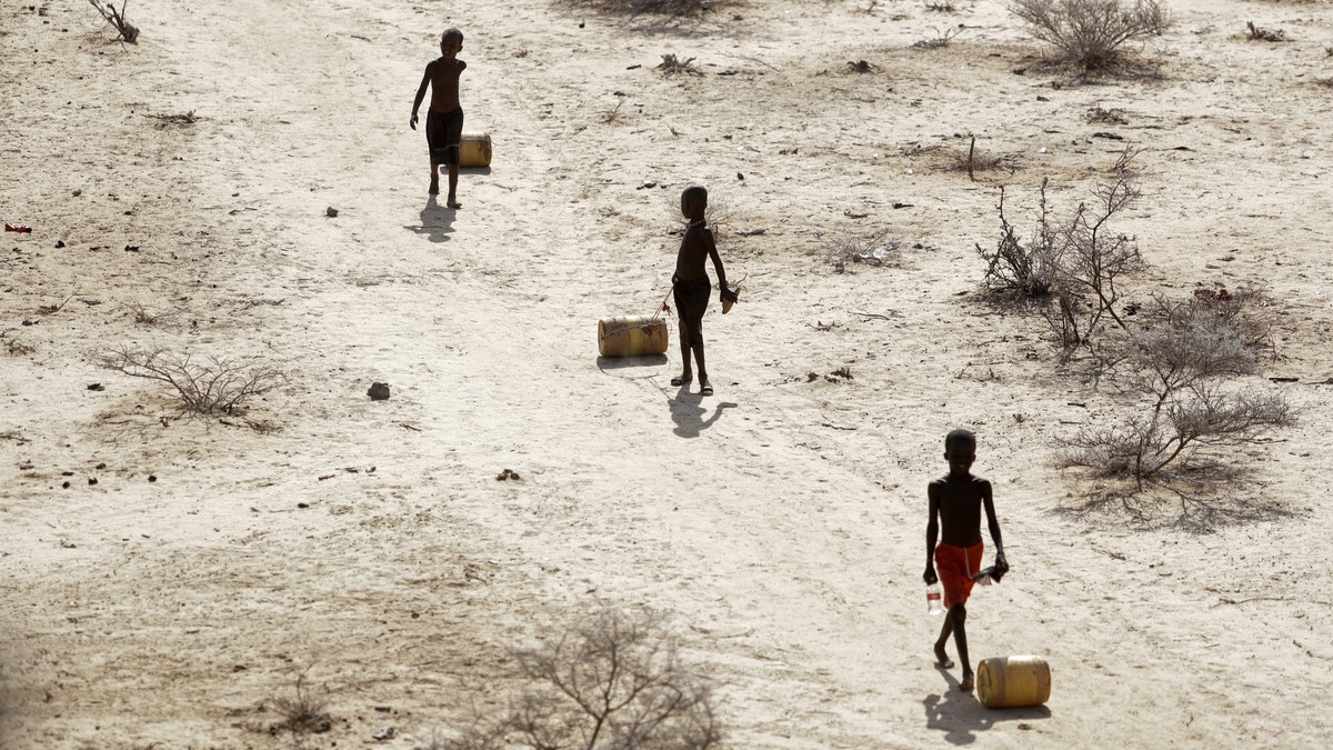 FILE - Young boys pull containers of water as they return to their huts from a well in the village of Ntabasi amid a drought in Samburu East, Kenya, Oct, 14, 2022. Tropical Cyclone Freddy, which has a ...