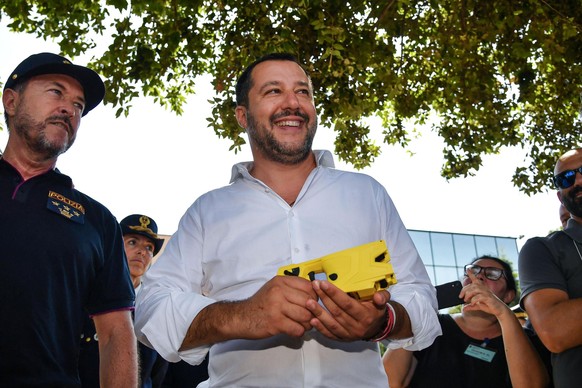 epa07691640 Italian Deputy Premier and Interior Minister Matteo Salvini holds a taser during the visit to the National Center of specialization and refinement in shooting, in Nettuno, Italy, 03 July 2 ...