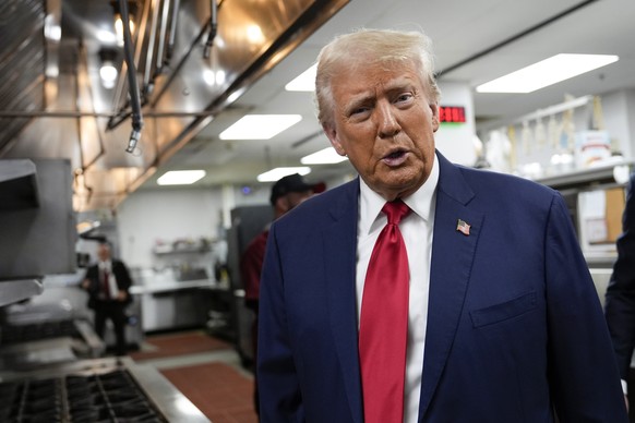 Republican presidential nominee former President Donald Trump talks as he walks through the kitchen of ll Toro E La Capra during a campaign event, Friday, Aug. 23, 2024, in Las Vegas. (AP Photo/Julia  ...