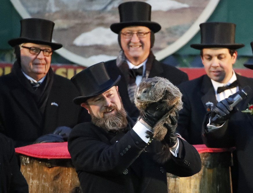 Groundhog Club co-handler Al Dereume holds Punxsutawney Phil, the weather prognosticating groundhog, during the 132nd celebration of Groundhog Day on Gobbler&#039;s Knob in Punxsutawney, Pa. Friday, F ...