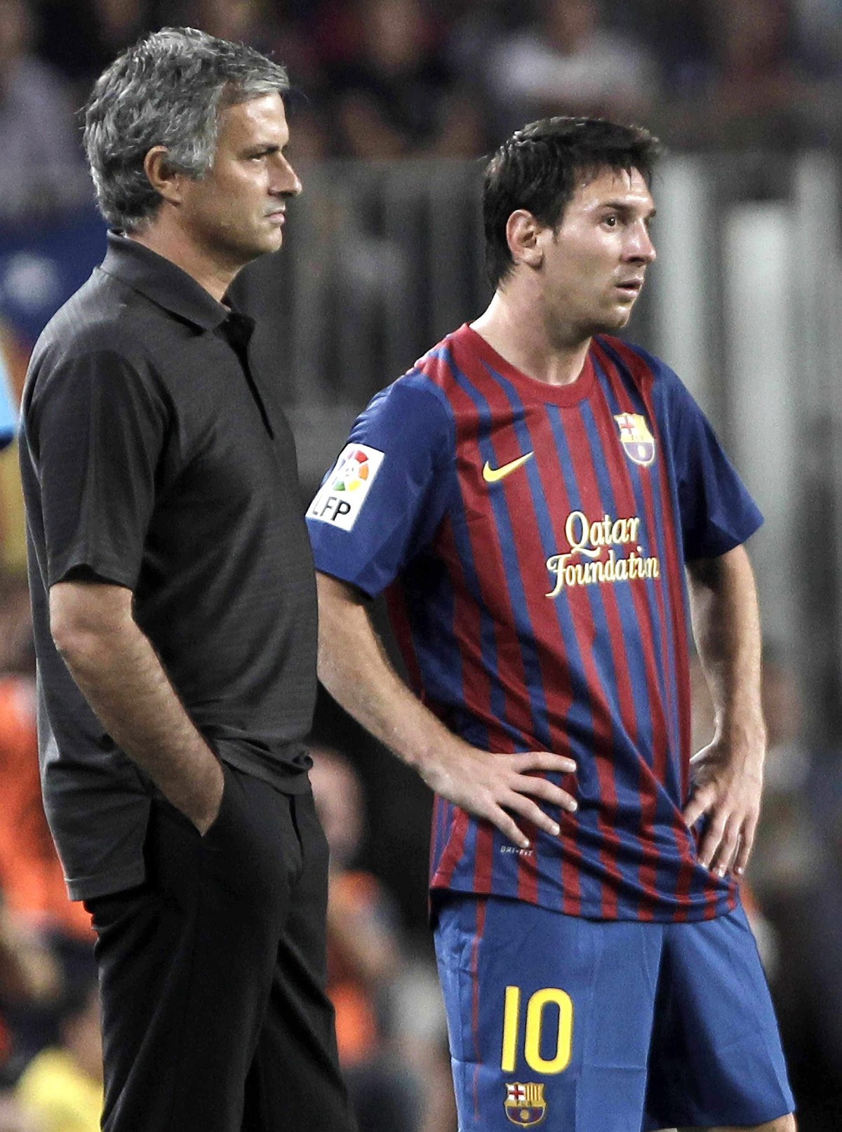 epa02870346 FC Barcelona's Lionel Messi (R) and Real Madrid coach Jose Mourinho during the Super Cup second leg match between Barcelona and Real Madrid at the Nou Camp stadium in Barcelona, Spain ...