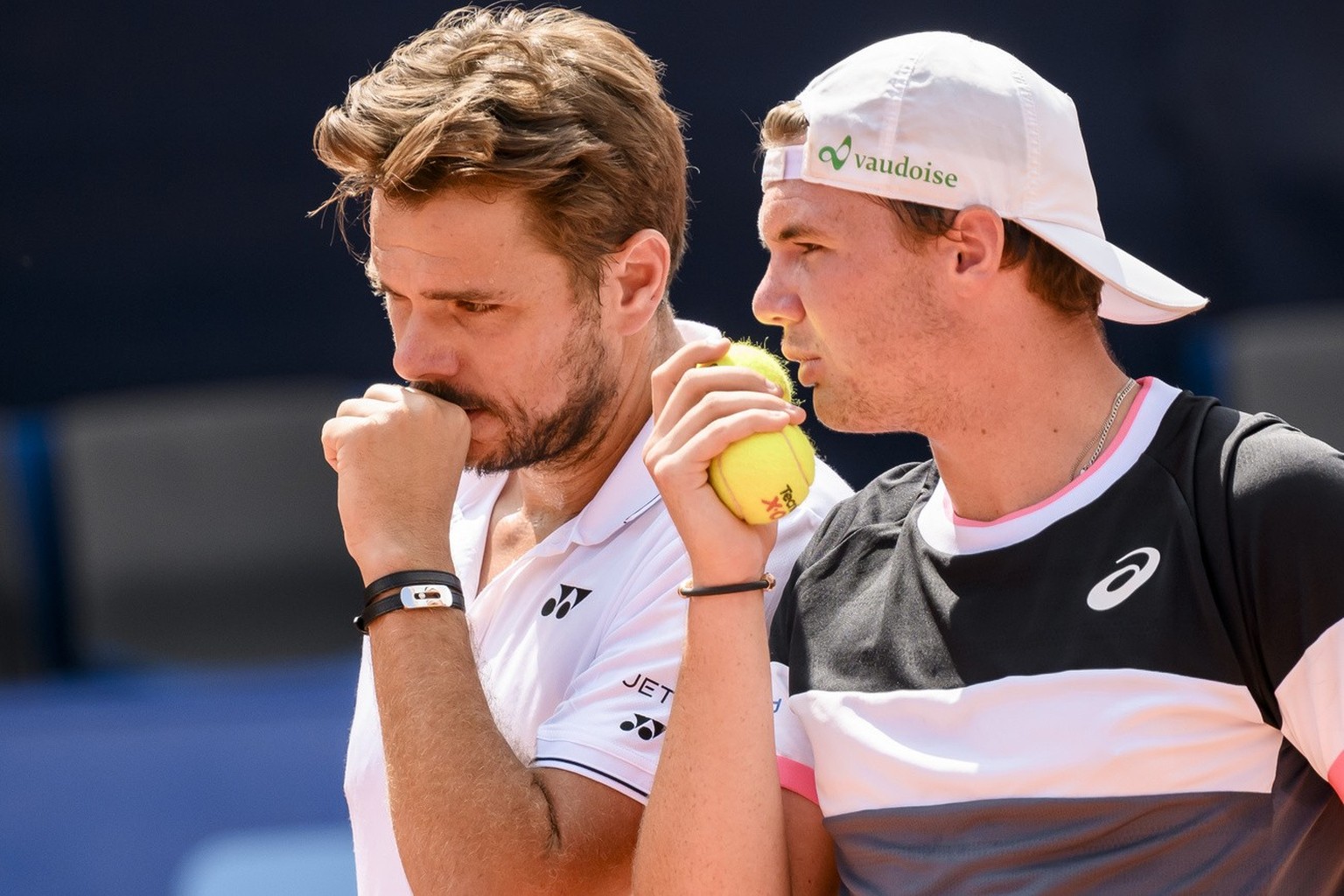 Stan Wawrinka talks with Dominic Stricker of Switzerland against Marcelo Demoliner of Brazil and Matwe Middelkoop of Netherlands during their doubles final game at the Swiss Open tennis tournament in  ...