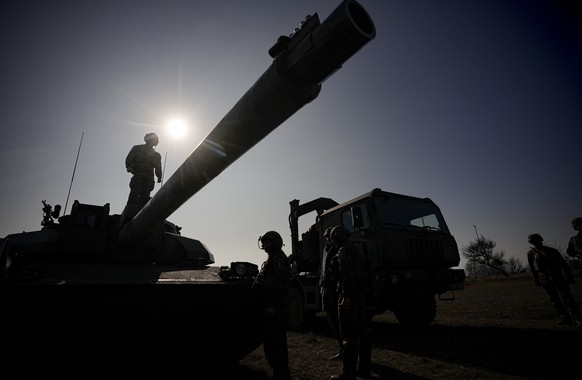 FILE - A French serviceman stands on a Leclerc main battle tank during a joint French US exercise in Capu Midia, on the Black Sea shore, Romania, Thursday, Feb. 9, 2023. France?s parliament has approv ...