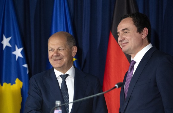 epa10005567 German Chancellor Olaf Scholz (L) accompanied by Kosovo&#039;s Prime Minister Albin Kurti (R) leave a joint press conference in Pristina, Kosovo, 10 June 2022. Scholz is on a one-day offic ...