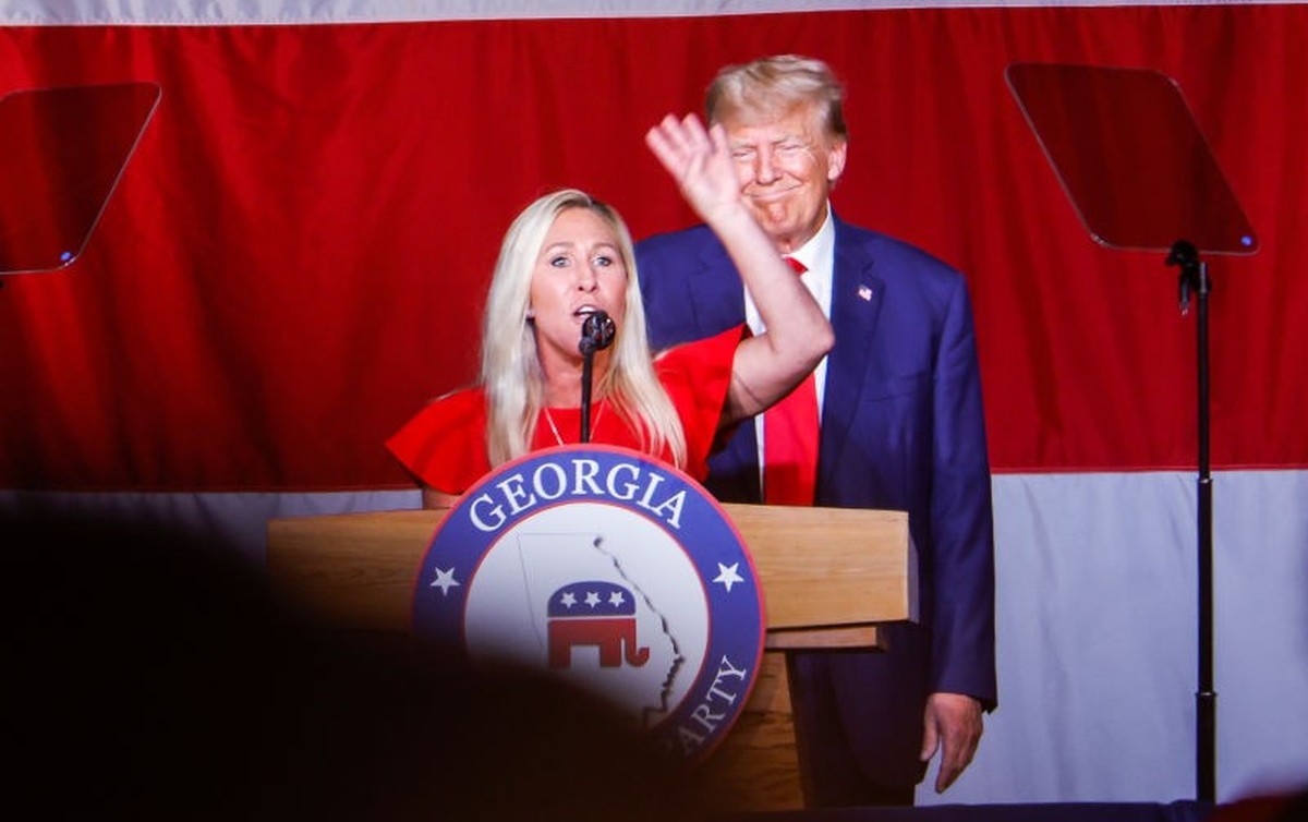 COLUMBUS, GEORGIA - JUNE 10: Former U.S. President Donald Trump looks on as Rep. Marjorie Taylor Greene (R-GA) speaks during his remarks at the Georgia state GOP convention at the Columbus Convention  ...