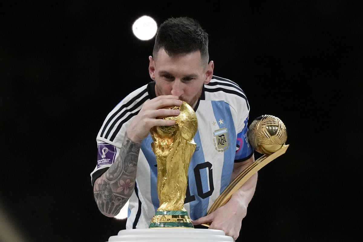 Argentina's Lionel Messi kisses the trophy after winning the World Cup final soccer match between Argentina and France at the Lusail Stadium in Lusail, Qatar, Sunday, Dec. 18, 2022. Argentina won ...
