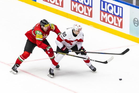 epa12114950 Hungary&#039;s Zsombor Garat (L) in action against Switzerland&#039;s Nicolas Baechler during the IIHF 2025 World Championship preliminary round group B game between Hungary and Switzerlan ...