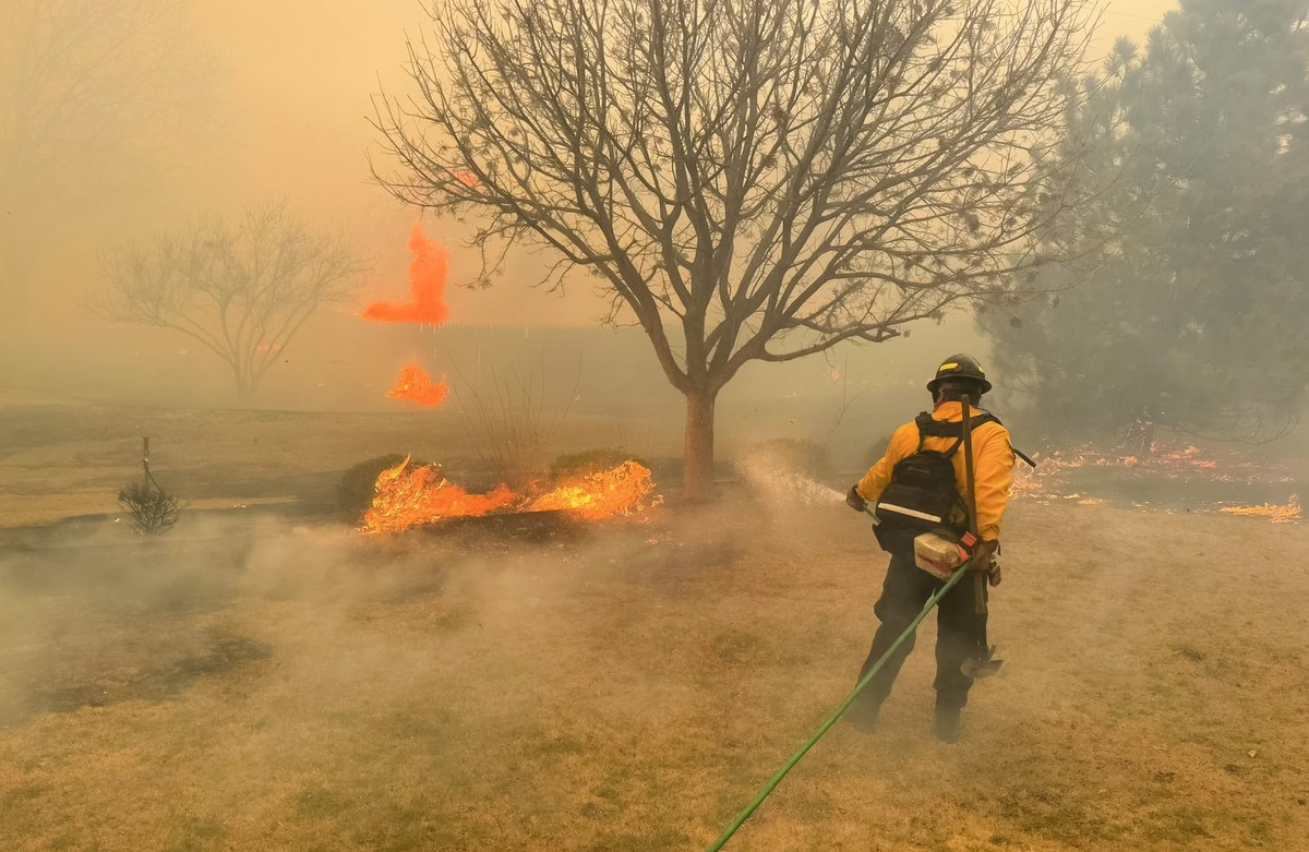 epa11187470 A handout photo made available by the Flower Mound Fire Department shows firefighters with the Flower Mound Fire Department out of Flower Mound, Texas, helping to contain a wildfire in the ...