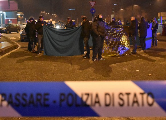 Italian Police officers work next to the body of Anis Amri, the suspect in the Berlin Christmas market truck attack, in a suburb of the northern Italian city of Milan, Italy December 23, 2016. REUTERS ...