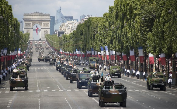 epa06086904 French military armored vehicles drive down the Champs-Elysees as they take part in the traditional military parade as part of the Bastille Day celebrations in Paris, France, 14 July 2017. ...