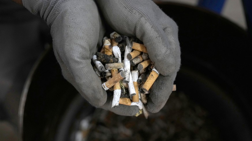 A worker separates waste at a recycling plant built on old landfill site on the Aegean Sea island of Tilos, southeastern Greece, Monday, May 9, 2022. When deciding where to test green tech, Greek poli ...