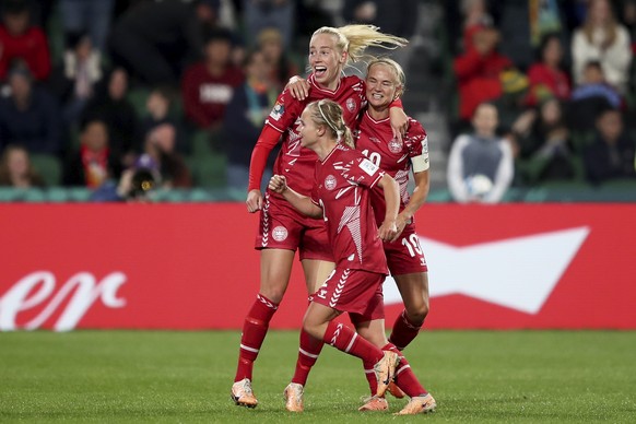 Amalie Vangsgaard, of Denmark, celebrates with Pernille Harder, right, and Josephine Hasbo, front, after scoring the opening goal during the Women's World Cup Group D soccer match between the...
