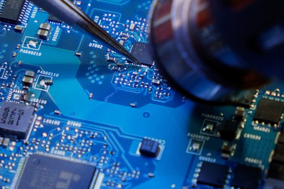 Technesia owner and repair technician Daniel Fernando solders a computer chip from a motherboard following the announcement of President Donald Trump&#039;s reciprocal tariffs on Wednesday, April 2, 2 ...