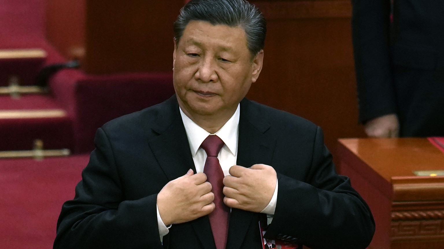 Chinese President Xi Jinping adjusts his jacket during the closing session of the National People&#039;s Congress held at the Great Hall of the People in Beijing, Monday, March 11, 2024. This year, Ch ...