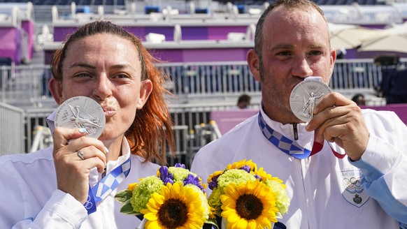 Silver medalists Alessandra Perilli, left, and Gian Marco Berti, both of San Marino, celebrate after competing in the mixed team trap at the Asaka Shooting Range in the 2020 Summer Olympics, Saturday, ...