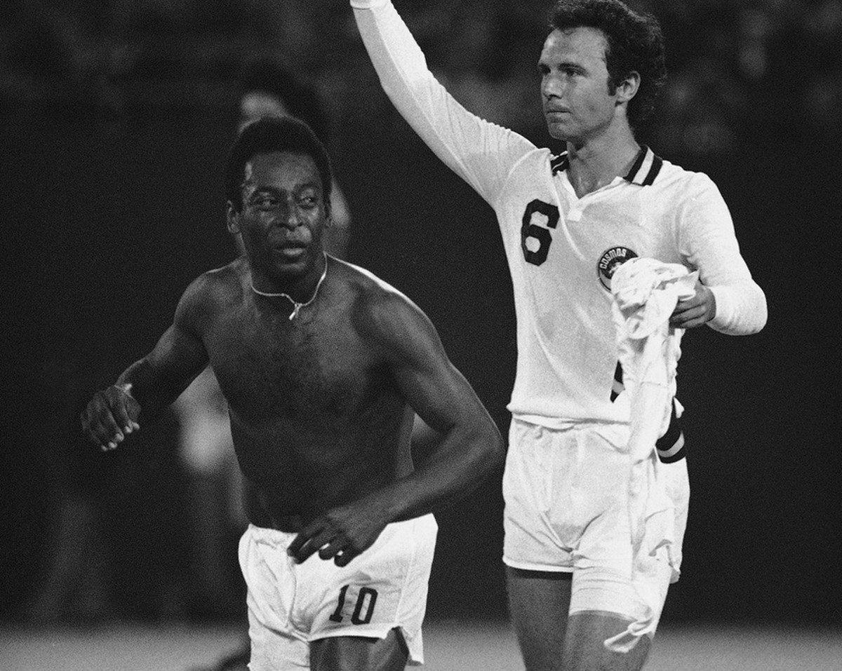 Pele, who came out of retirement to play in Wednesday's New York Cosmos Vs. NASL All-Stars exhibition game to honor Beckenbauer, leaves the game after giving Beckenbauer, right, the gift of jerse ...