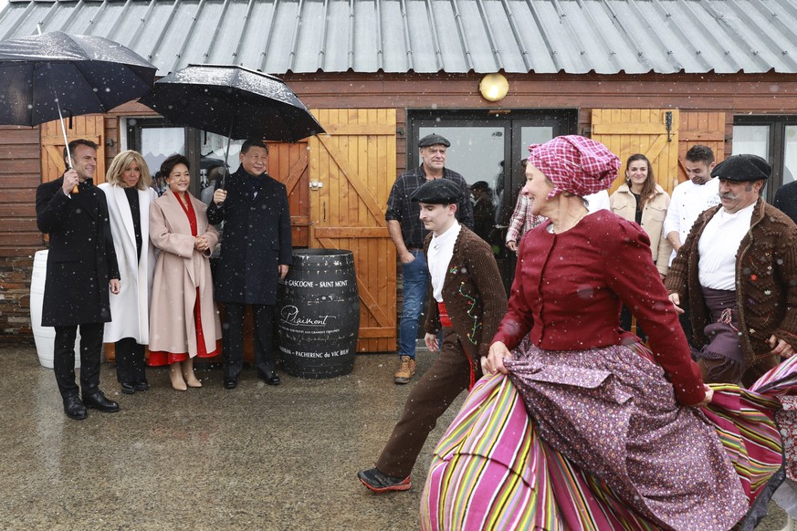 French President Emmanuel Macron and his wife Brigitte Macron, Chinese President Xi Jinping, and his wife Peng Liyuan watch folklore dancers, Tuesday, May 7, 2024 at the Tourmalet pass, in the Pyrenee ...