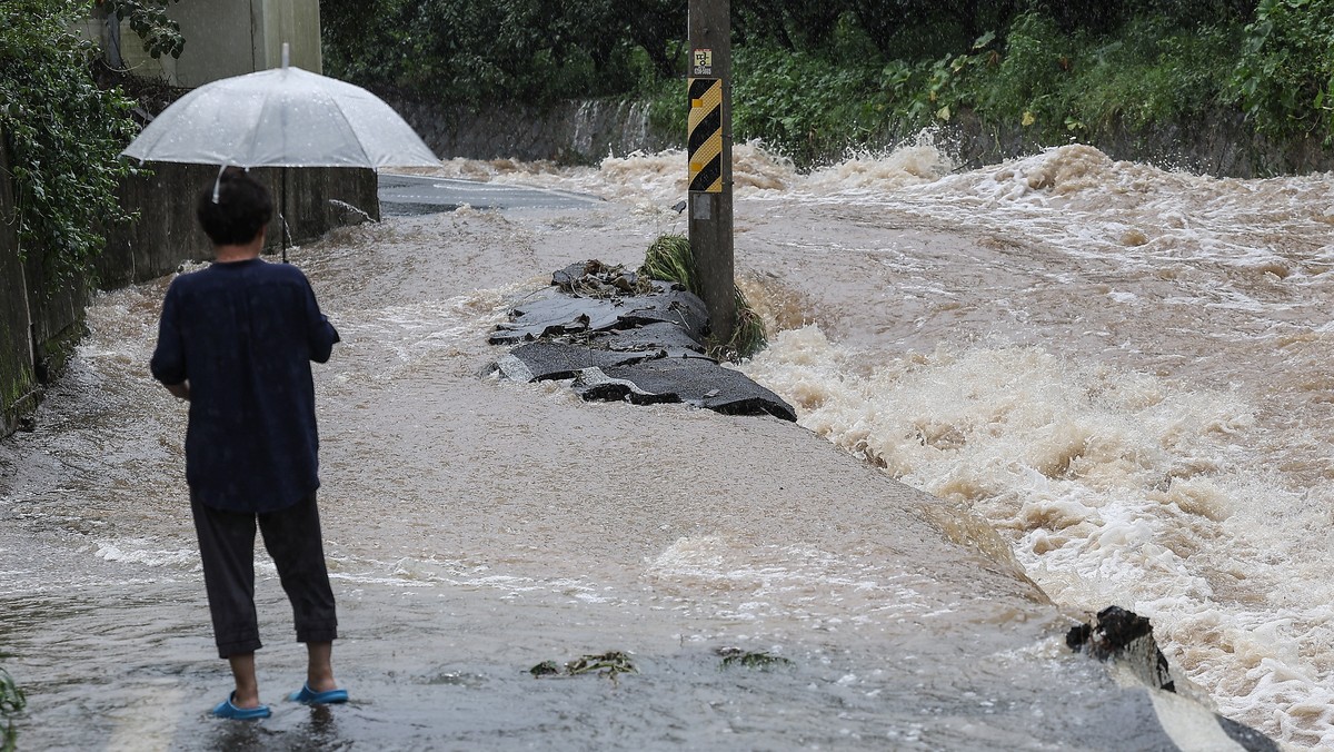 epa10792826 A road leading to a village is submerged, in Daegu, South Korea, 10 August 2023, as heavy rainfall and strong winds from Typhoon Khanun caused flooding, landslides and extensive facility d ...