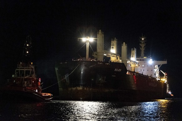 The cargo ship flying the Maltese flag Rojen, loaded with Ukrainian corn seeds, that left from Chornomorsk near Odessa, is towed to Ravenna port in Italy, Friday night, Aug. 12, 2022. (Guido Calamosca/LaPresse via AP)