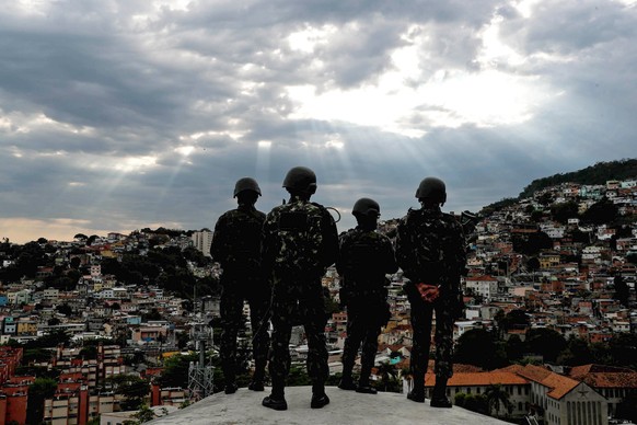 epa06292922 Members of the Brazilian Armed Forces, the National Force and the Policestand on a hill overlooking a part of the Morro da Mineira favela in the Catumbi district of Rio de Janeiro, Brazil, ...