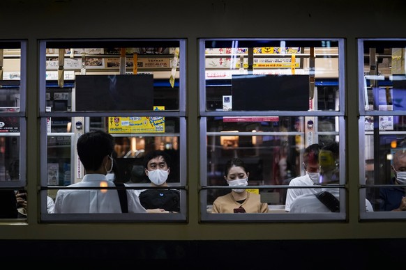 epa08589856 Passengers wearing protective face masks are seen in a tram in central Nagasaki, southern Japan, 07 August 2020. Nagasaki is preparing to mark the 75th anniversary of the atomic bombing on ...