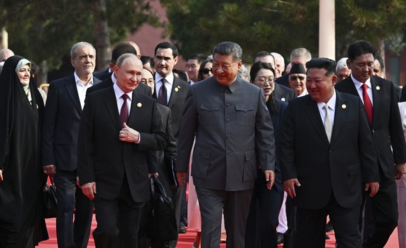 From left in the front row: Russian President Vladimir Putin, Chinese President Xi Jinping and North Korean leader Kim Jong Un walk after a joint photo session of the heads of foreign delegations invi ...