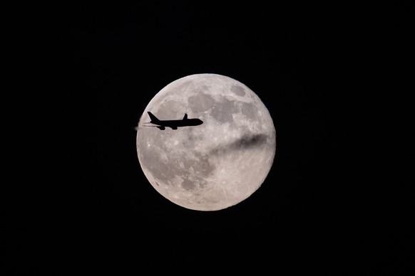 A UPS Boeing 747 inbound from Anchorage, Alaska, passes in front of the supermoon as it approaches Louisville Muhammad Ali International Airport on Wednesday, Nov. 5, 2025, in Louisville, Ky. (AP Phot ...