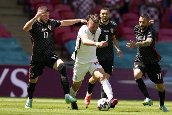 Croatia&#039;s Marcelo Brozovic, right, and Ante Rebic, left, vies for the ball with England&#039;s Kalvin Phillips during the Euro 2020 soccer championship group D match between England and Croatia a ...