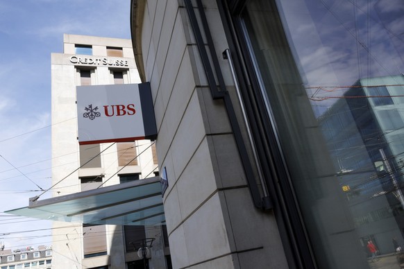 The logos of the Swiss banks UBS and Credit Suisse are displayed on different buildings in Geneva, Switzerland, Monday, March 20, 2023. The bank UBS takes over Credit Suisse for 2 billion US dollars.  ...