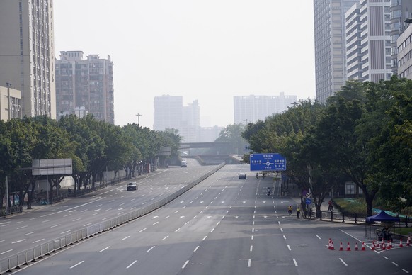 Few cars are seen on the empty street in the recently locked down Haizhu district in Guangzhou in southern China's Guangdong province Friday, Nov. 11, 2022. As the country reported 10,729 new COVID ca ...