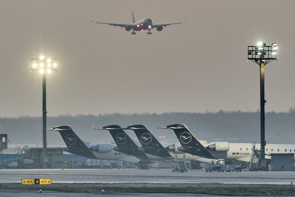 FILE - A plane comes in for landing as Lufthansa aircraft are parked at the airport due to a two-day strike by Lufthansa pilots, in Frankfurt, Germany, Thursday, March 12, 2026. (AP Photo/Michael Prob ...