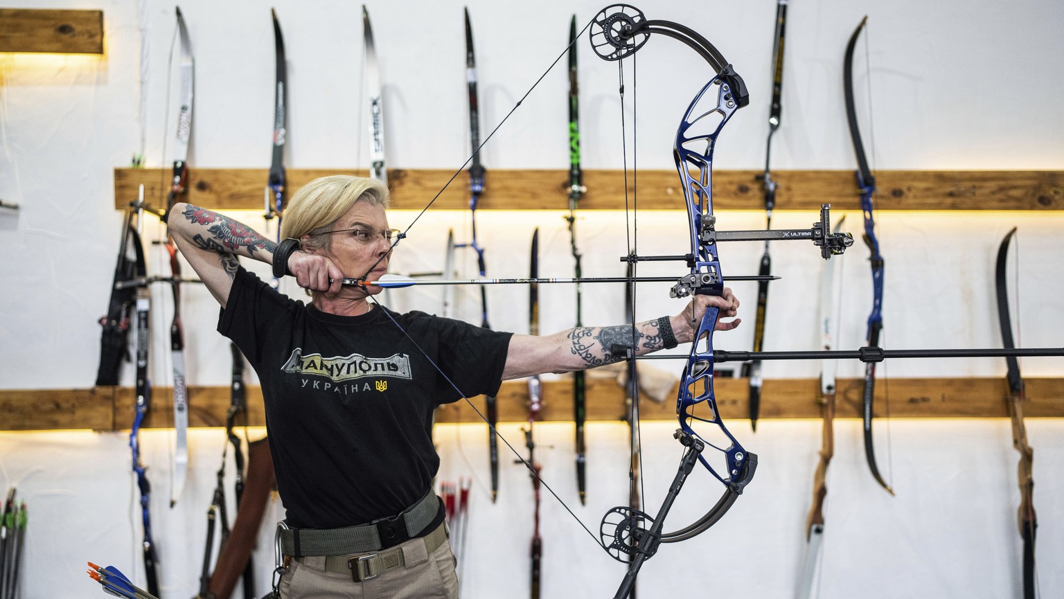 Ukrainian medic Yuliia Paievska, known as Taira, shoots a bow during the archery training in Kyiv, Ukraine, on Friday, July 8, 2022. The celebrated Ukrainian medic who was held captive by Russian forc ...