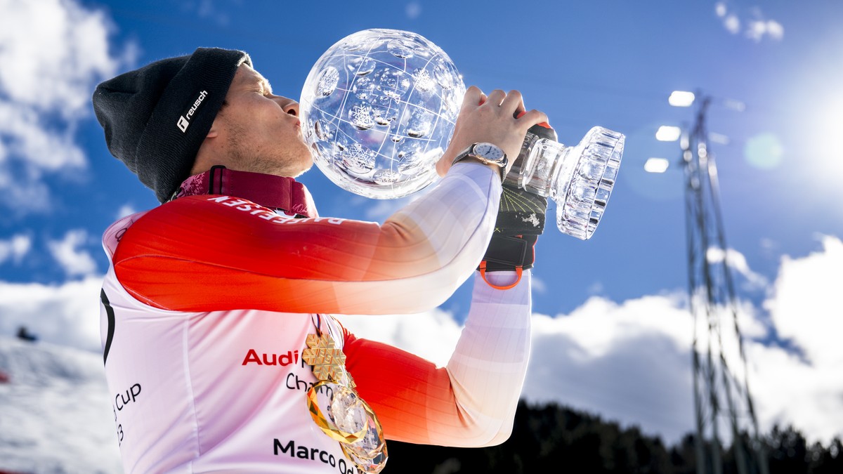 Marco Odermatt of Switzerland poses with the men's overall crystal globe trophy after the podium ceremony at the FIS Alpine Skiing World Cup finals in Soldeu, Andorra, Sunday, March 19, 2023. (KE ...