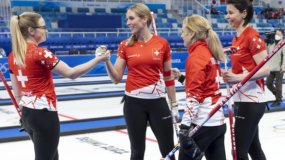 Switzerland skip Silvana Tirinzoni, 2nd right, and her teammates Alina Paetz, left, Melanie Barbezat,2nd left, and Esther Neuenschwander, right, celebrate after defeating the Canada team during the wo ...