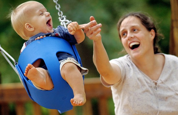 Eliza Gallagher, right, plays with her 11-month-old son Aidan Gallagher, left, on a baby swing at Veterans Park in Pendleton, S.C. Monday, Oct. 10, 2005. Gallagher and several friends brought their ch ...