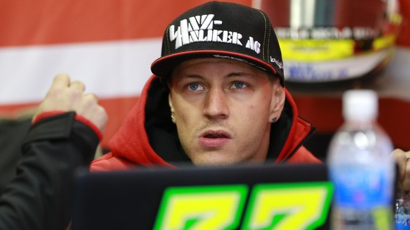 Moto2 rider Dominique Aegerter of Switzerland looks at a monitor during the free practice session for the MotoGP Japanese Motorcycle Grand Prix at the Twin Ring Motegi circuit in Motegi, north of Toky ...