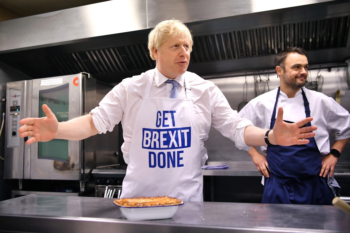 Britain's Prime Minister Boris Johnson prepares a pie at the Red Olive catering company while on the campaign trail, in Derby, England, Wednesday, Dec. 11, 2019 Britain goes to the polls on Dec.  ...