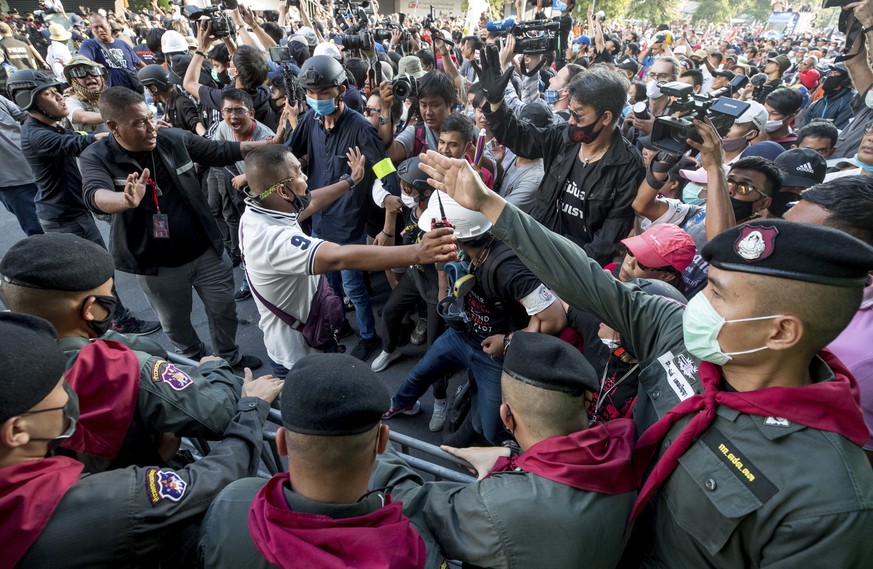 Leaders direct pro-democracy protesters as they arrive near the Government House in Bangkok, Thailand, Wednesday, Oct. 14, 2020. Thousands of anti-government protesters gathered Wednesday for a rally  ...