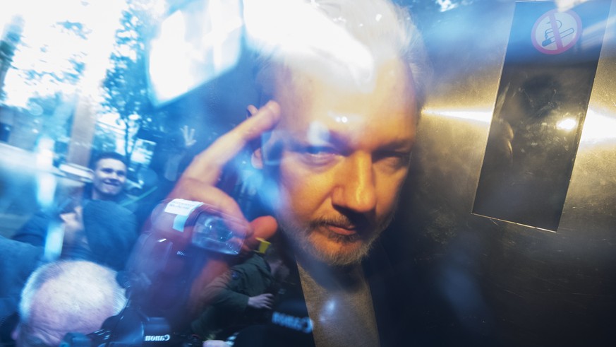 epa07540147 Wikileaks co-founder Julian Assange, in a prison van, as he leaves Southwark Crown Court in London, Britain, 01 May 2019. The Wikileaks co-founder Julian Assange has been sentenced to 50 w ...