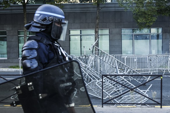 epa12366689 A police officer passes next to a barricade during a protest in Porte de Montreuil at the entrance to Paris, France, 10 September 2025. To protest against the outgoing government&#039;s au ...