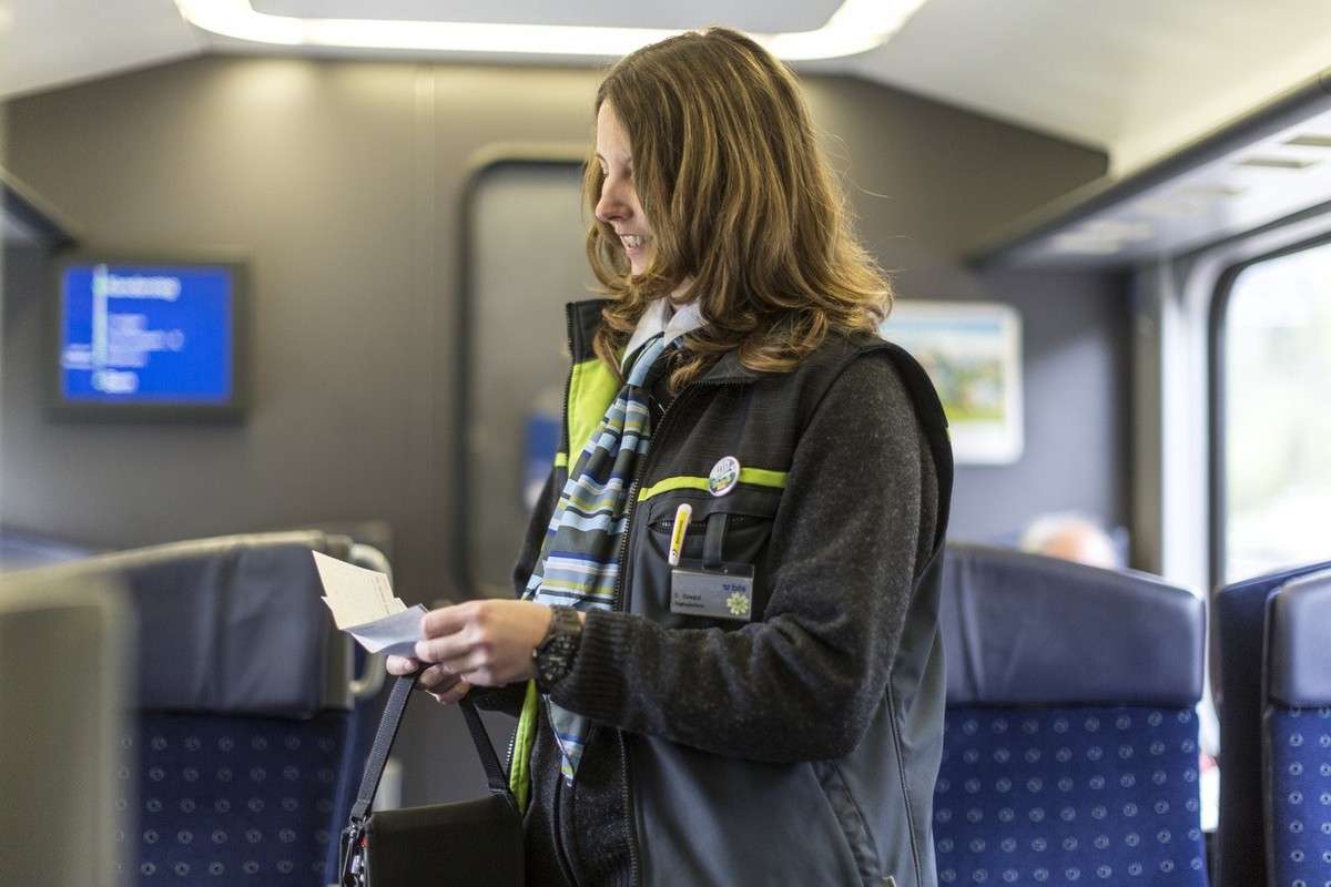 The BLS ticket inspector checks the passengers' tickets in the train from Brig to Berne, Switzerland, pictured on May 30, 2013, on the railway line Berne-Goppenstein-Berne of the BLS, a Swiss rai ...