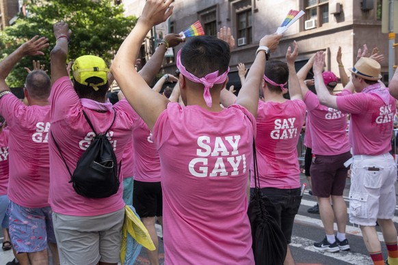 epa10035874 Marchers for the New York City Gay Men&#039;s Chorus perform while wearing t-shirts that have &#039;Say Gay&#039; on the back during the Pride March in New York, New York, USA, 26 June 202 ...