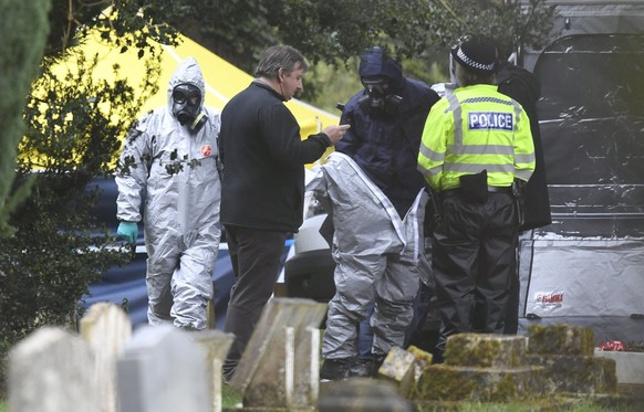 epa06593431 Forensic police officers work at a grave site in Salisbury Crematorium in Salisbury, southern England, 10 March 2018. Russian ex-spy Sergei Skripal and his daughter Yulia Skripal were atta ...