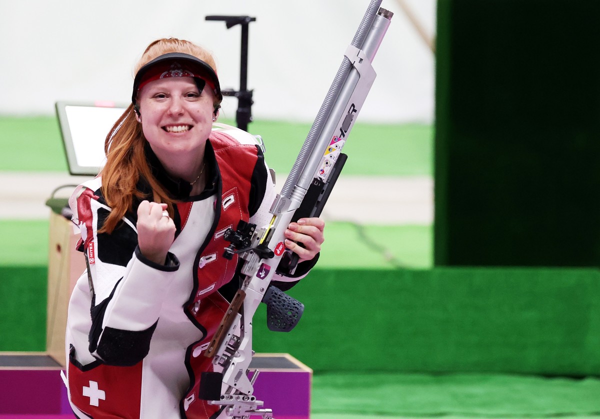 epa09360668 Third placed Nina Christen of Switzerland celebrates at the end of the 10m Air Rifle Women's Final of the Shooting events of the Tokyo 2020 Olympic Games at the Camp Asaka in Nerima,  ...