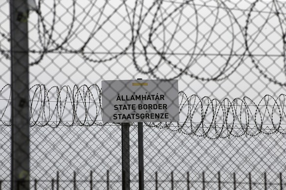 FILE - In this file photo dated Monday, April 8, 2019, a sign reading: &quot;State Border&quot; is attached to a fence at Hungary&#039;s border with Serbia near the village Asotthalom, Hungary. The Eu ...